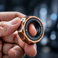 D12 magnetic decision ring held in hand — 12 numbered bronze facets, GAME WHEEL inner band