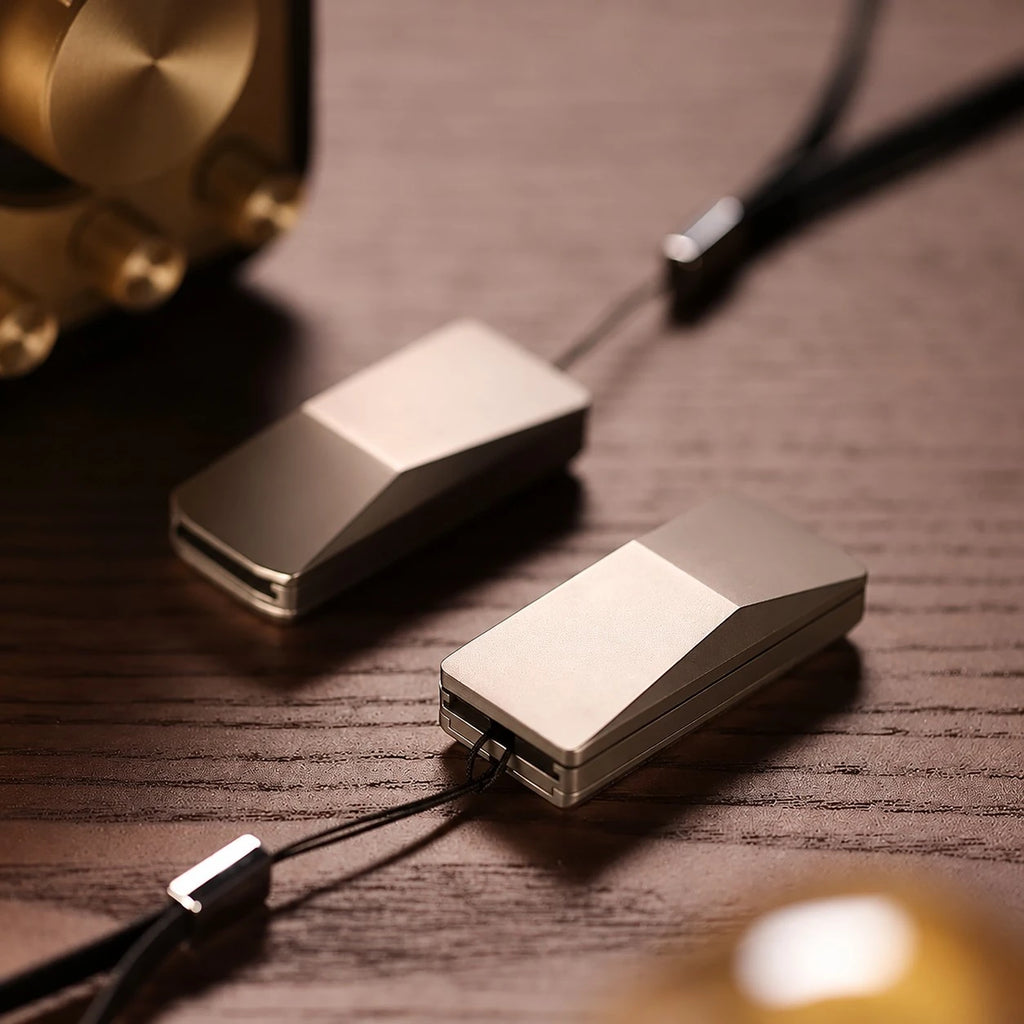 THE CYBER fidget slider — wedge body, one closed one open, on a wood desk