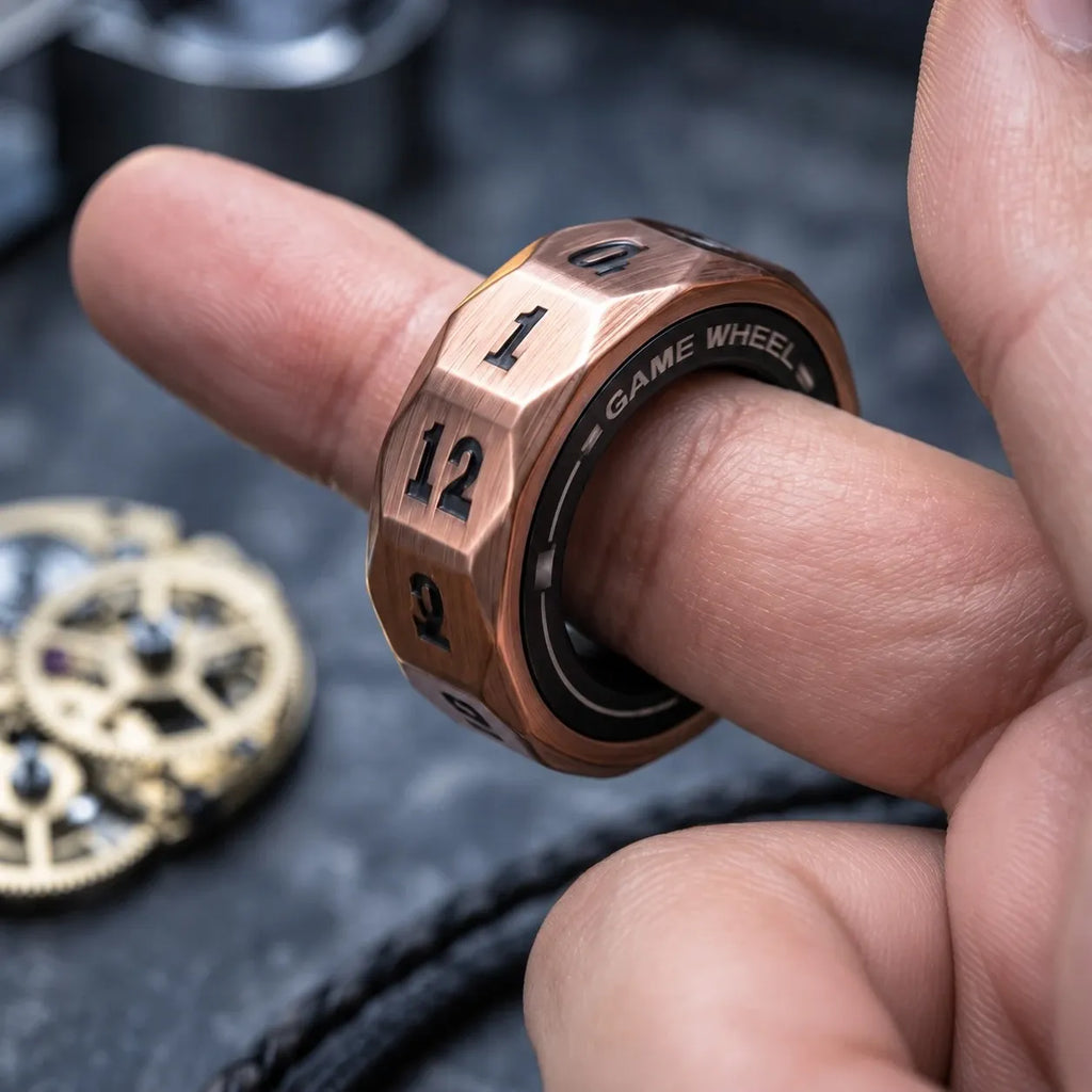 D12 magnetic decision ring worn on a finger — 12 numbered facets, GAME WHEEL inner band