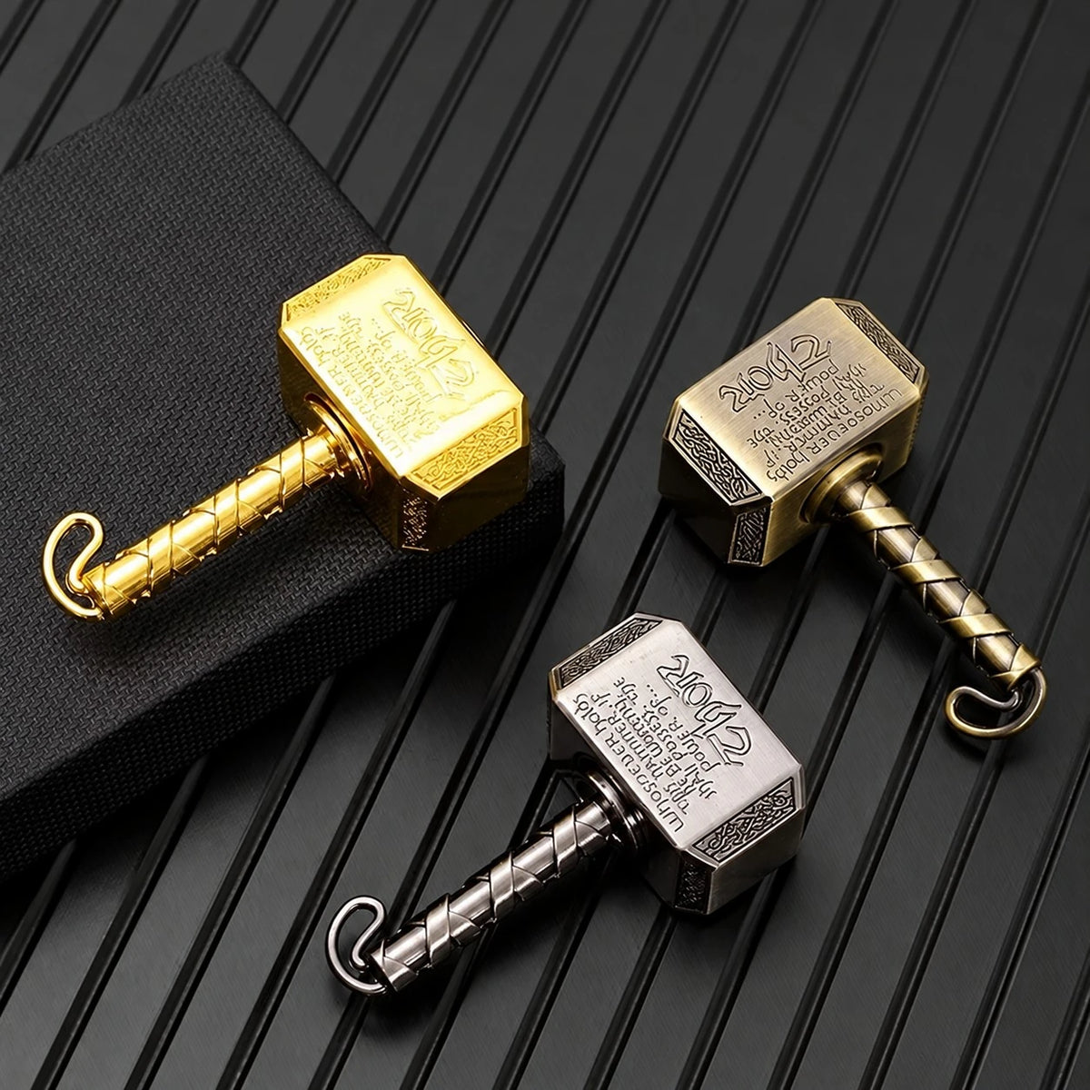 EDCFORCE hammer fidget spinners on a black textured mat